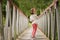 Cute little girl having fun in a rural bridge