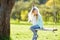 Cute little girl having fun on a swing outdoors in summer garden. Summer leisure for kids