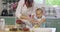 Cute little girl helping her mother bake