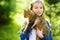 Cute little girl with her cat on sunny autumn day. Adorable child holding het pet kitty.