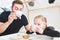 Cute little girl and her father drink tea with cookies at home.