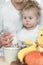 Cute little girl with her father drinking milk over window background