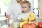 Cute little girl with her father drinking milk over window background