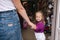 Cute little girl with her mom go into toy store. Happy kid choosing toys with mother. Mom and daughter buying toys in