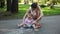 Cute little girl and her mother drawing with chalk on sidewalk at summer park. Family, motherhood and people concept