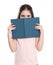 Cute little girl hiding behind book. Reading activity