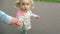 Cute little girl holding father hand and walk together