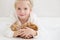 Cute little girl holding a kitten on a ginger hand