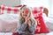 Cute little girl holding a peppermint lollipop at Christmastime