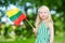 Cute little girl holding tricolor Lithuanian flag