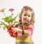 Cute little girl holding vase with flowers