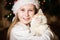 Cute little girl hugging her cat in Christmas