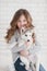 Cute little girl hugging husky puppy on a white background