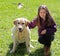 cute little girl with labrador dog on the grass