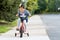 Cute little girl learning ride a bicycle with no helmet