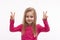 A cute little girl with long blonde hair  shows victory gesture with fingers, isolated