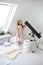 A cute little girl is looking at a telescope on an aluminum stargazing stand in a room