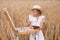 Cute little girl paints a picture of a wheat field