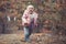 Cute little girl picking mushrooms in summer forest, looks at non edible poisonous mushrooms toadstools in forest, kids