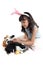 Cute little girl with pink bunny ears plays with rabbits during sitting on white background. Joyful kid celebrating Easter day.