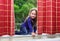 Cute little girl playing with drapes on the window