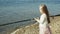 Cute little girl is playing with a fishing rod on a fishing boat near the river