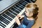 Cute little girl playing grand piano