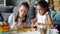 Cute little girl playing at home with caring mother having fun with wooden toys