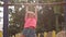 Cute little girl playing on playground and hanging on a horizontal bar. Slow motion