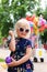 Cute Little Girl Playing with Water Balloon Yoyo at Small Town American Parade