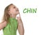 Cute little girl pointing her chin in body parts learning English words at school