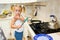 Cute little girl prepare pancakes in the kitchen
