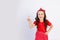 A cute little girl in a red outfit on a white isolated background shows a thumbs up. Space for text.the concept of the celebration