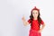 A cute little girl in a red outfit on a white isolated background shows a thumbs up. Space for text.the concept of the celebration