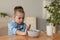 Cute little girl refusing to eat her breakfast at home