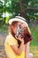 Cute little girl in retro outfit taking pictures with old film c