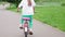 Cute little girl riding bicycle at park. Children Summer Activities and Family Health Concept