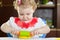 Cute little girl rolling clay dough with