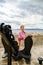 Cute little girl with ship anchor on the seaside