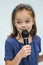 Cute little girl sings a karaoke song with microphone