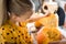 Cute little girl sitting on kitchen table, helping her father to carve large pumpkin, smiling. Halloween family lifestyle.