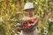 A cute little girl smiles and holds vegetables grown in the garden. Local rural seasonal natural food