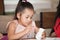 Cute little girl student painting a ceramic pottery model  in classroom school . kid artist . child sitting at desk preschool .