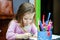 Cute little girl studing to speaking and writing letters at home