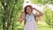 Cute little girl in summer dress. straw hat.