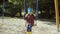 Cute little girl on the swing. Beautiful child have fun outside on the playground. Female in bride clothes, rubber boots