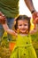 Cute little girl take hands with her father. Walking with kids concept image. Little girl holding hands with her parents. Smiling