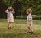 Cute little girl taking a phto of her younger brother