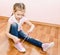 Cute little girl tying her shoes