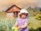 Cute little girl watering garden